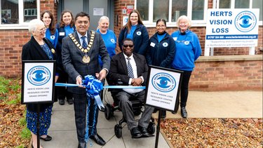 Staff stand outside Herts Vision Loss for its grand opening