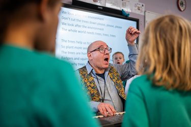 A teacher teaching the Tree Song for Arbor Day 2024