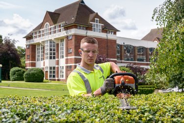 A gardener trims hedges in Letchworth