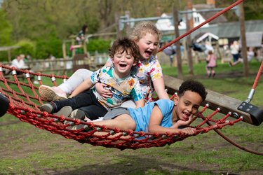 Children playing on a swing at Standalone Farm