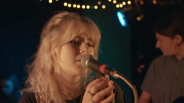 A person sings into a microphone