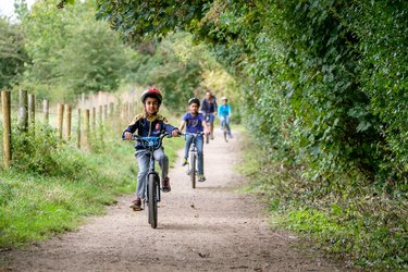 A family cycling through the Greenway
