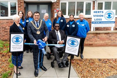 Staff stand outside Herts Vision Loss for its grand opening