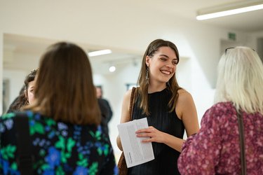 People chat at a social event at Broadway Gallery