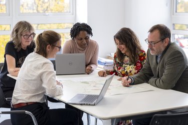 Staff at Letchworth Garden City Heritage Foundation sitting around a table